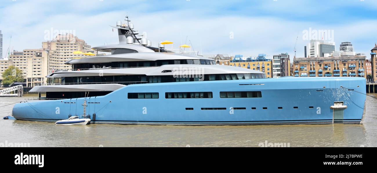 River Thames & mega yacht Aviva moored in Pool of London UK a super yacht built as a floating home & office for wealthy British businessman Joe Lewis Stock Photo