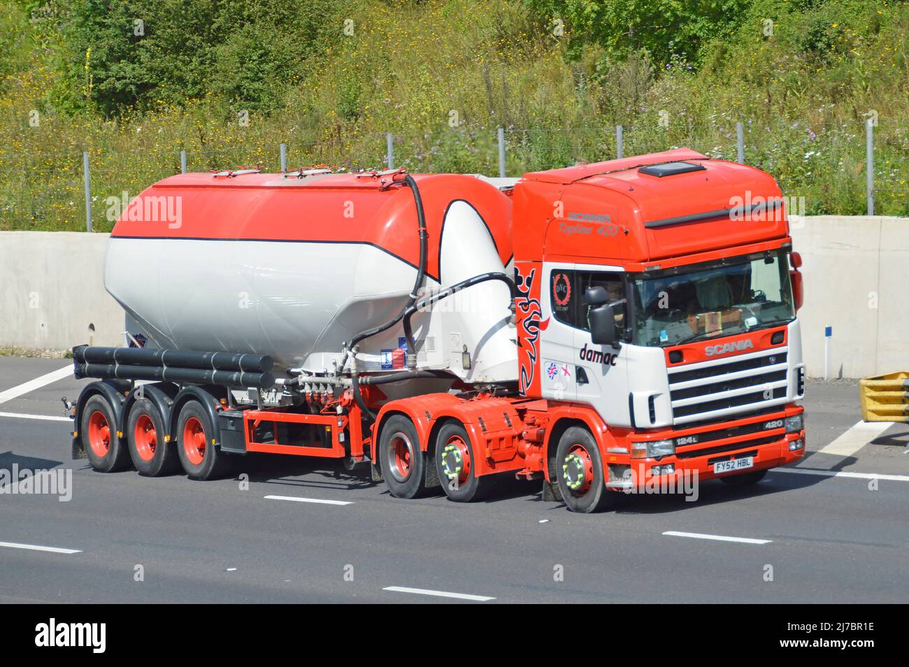 Side & front view SCANIA Topline hgv lorry truck & articulated tanker trailer by damac a UK bulk powder transport business driving on English motorway Stock Photo