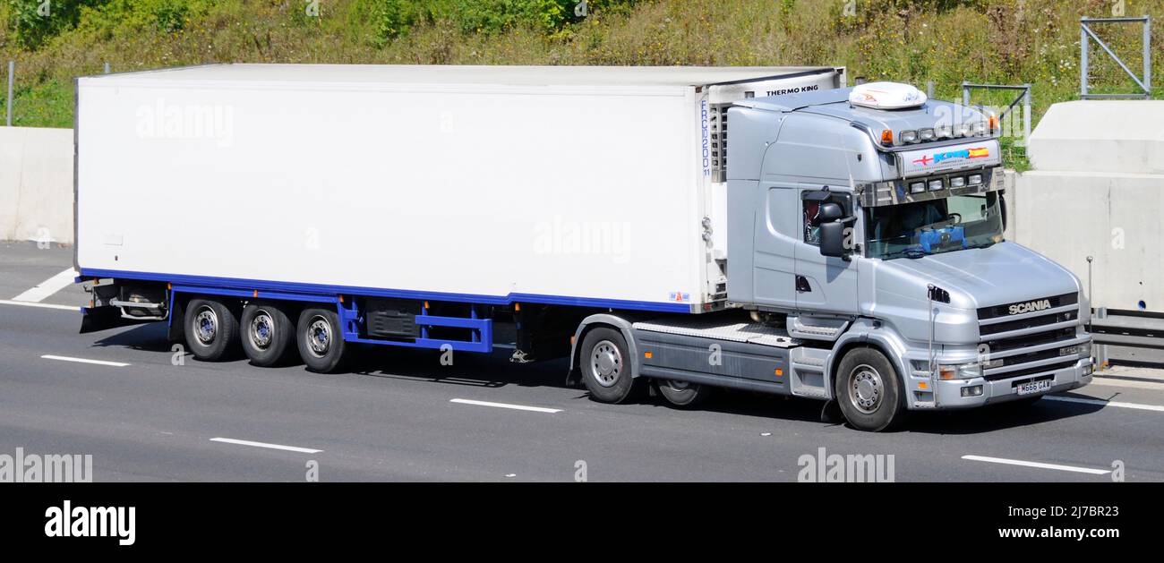 KNR logistics haulage contractor business grey bonneted hgv Scania  lorry truck white Thermo King cooler articulated trailer driving UK motorway road Stock Photo