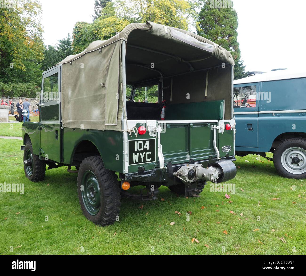 Rear view of a dark green Series I short wheel base, Land Rover with soft top canvas tilt. This also has the rear power take off, PTO, attachment. Stock Photo