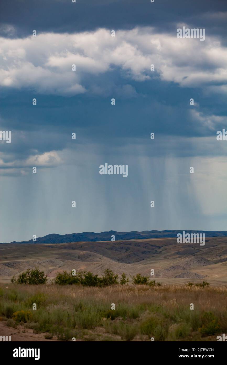 Storm cloud and rain over the mountains panoramic view. Kazakhstan, Almaty province. Stock Photo