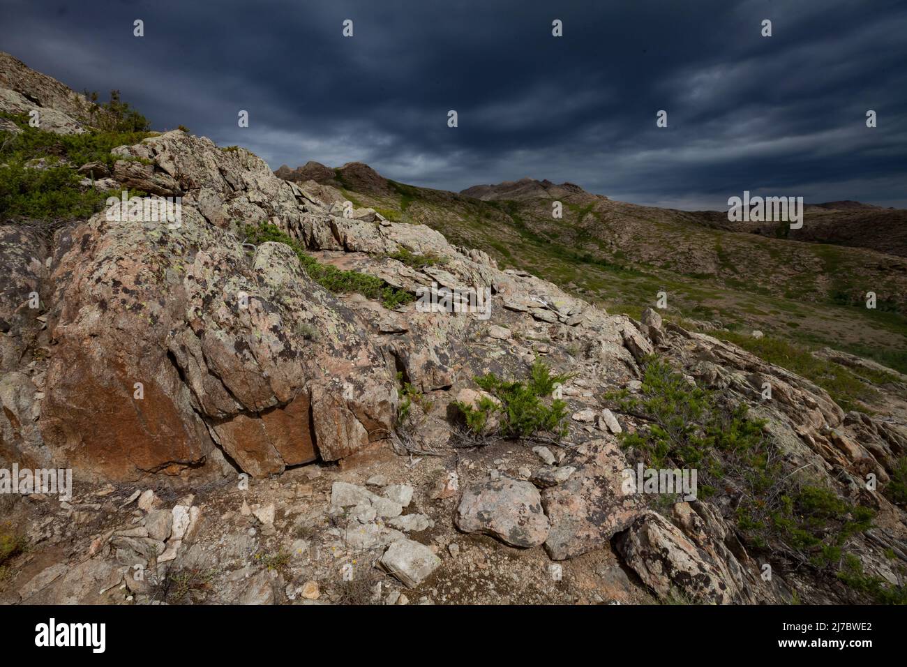 Wide-angle view on mountains and dark gray pre-storm sky. Ulytau, Kazakhstan. Aerial view Stock Photo