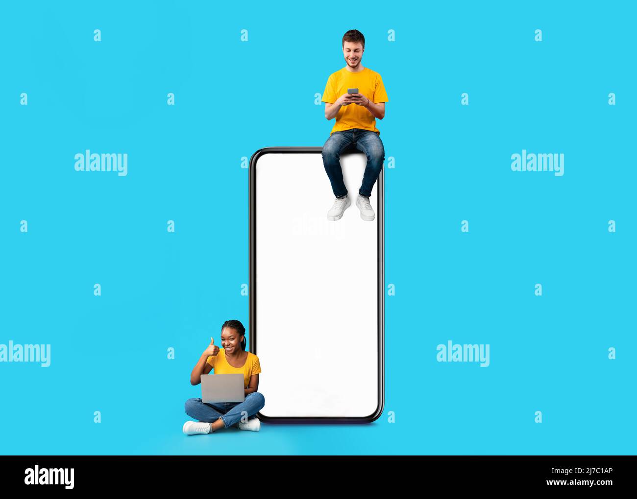 Couple sitting on white empty smartphone screen and using gadgets Stock Photo