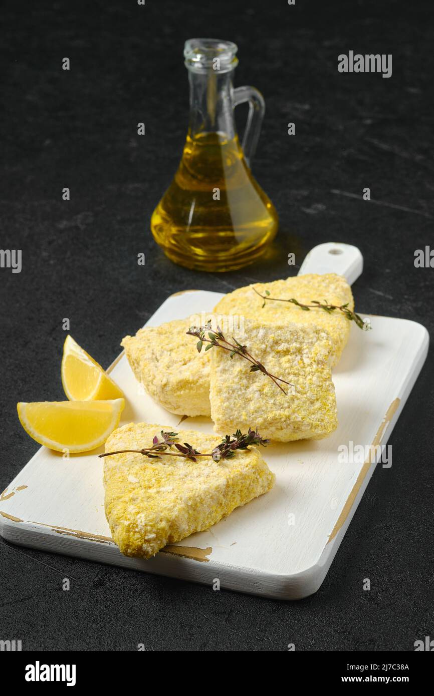 Semifinished frozen fish patty in breading for quick cooking Stock