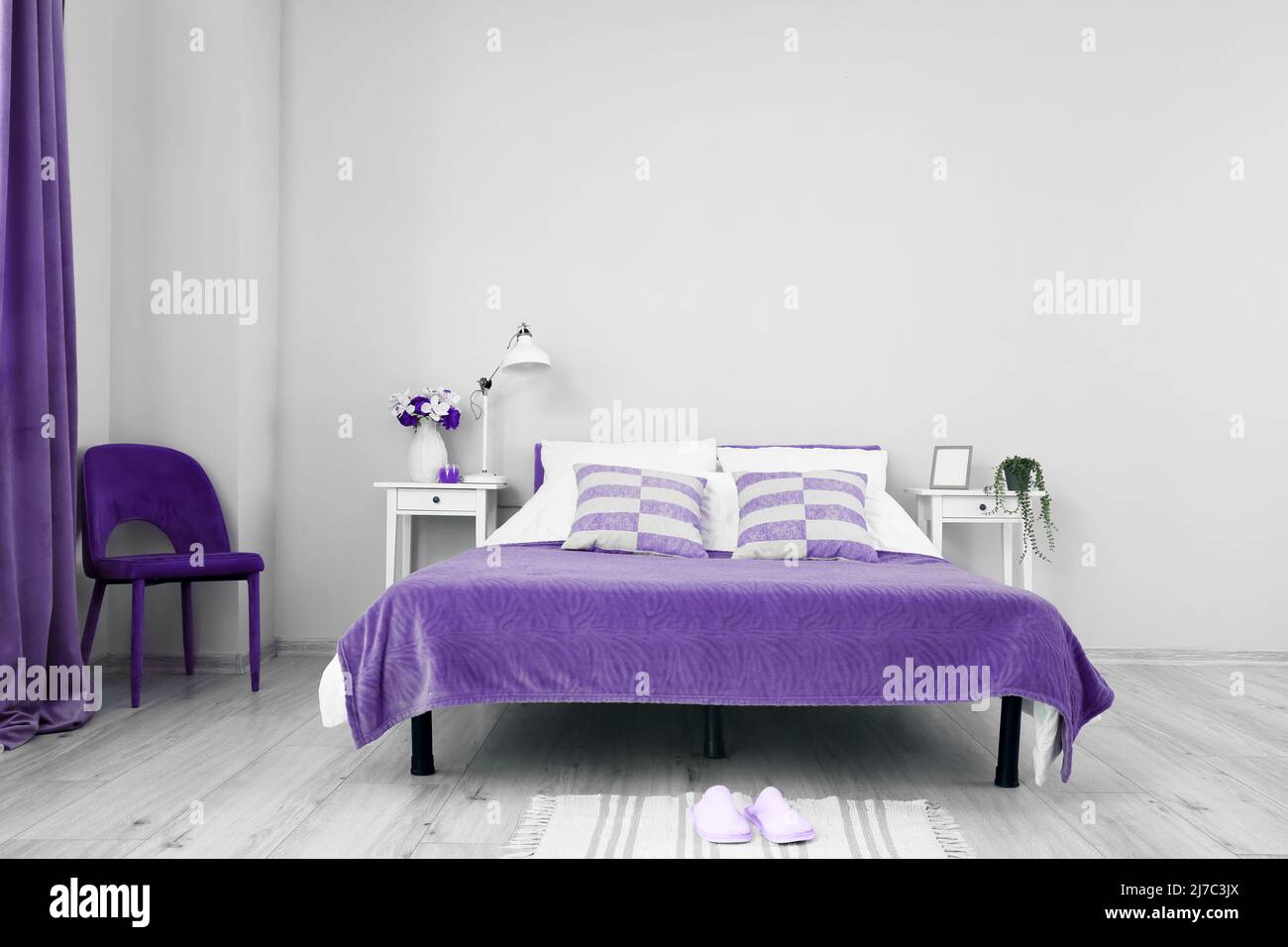 Interior of stylish room with bed, tables and chair Stock Photo Alamy