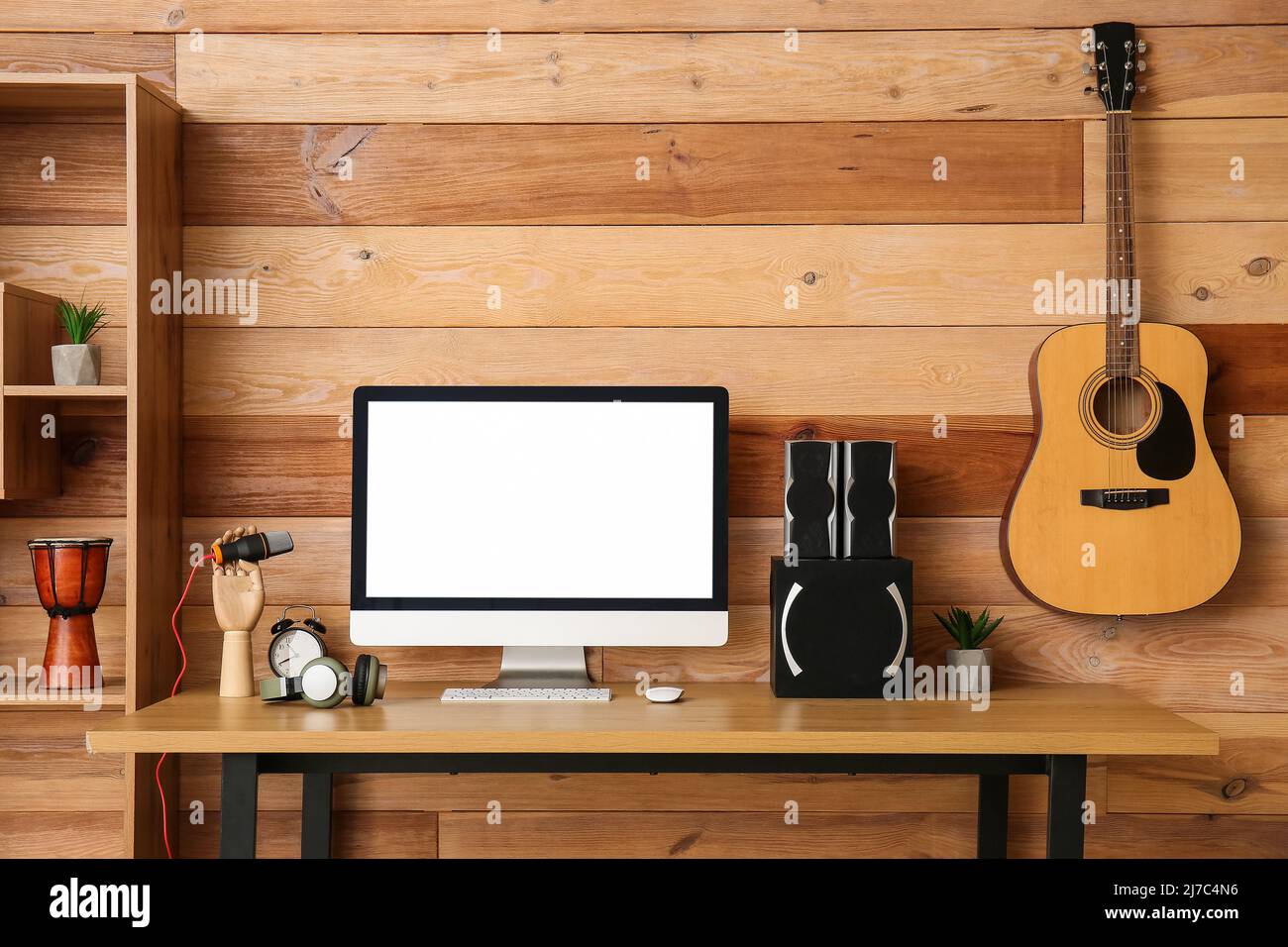 Workplace with modern computer, speakers and microphone near wooden