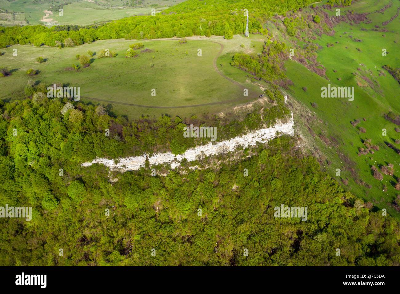 Aerial view of limestone cliffs and Green forest in the spring. Geological formation in Transylvania, Romania Stock Photo