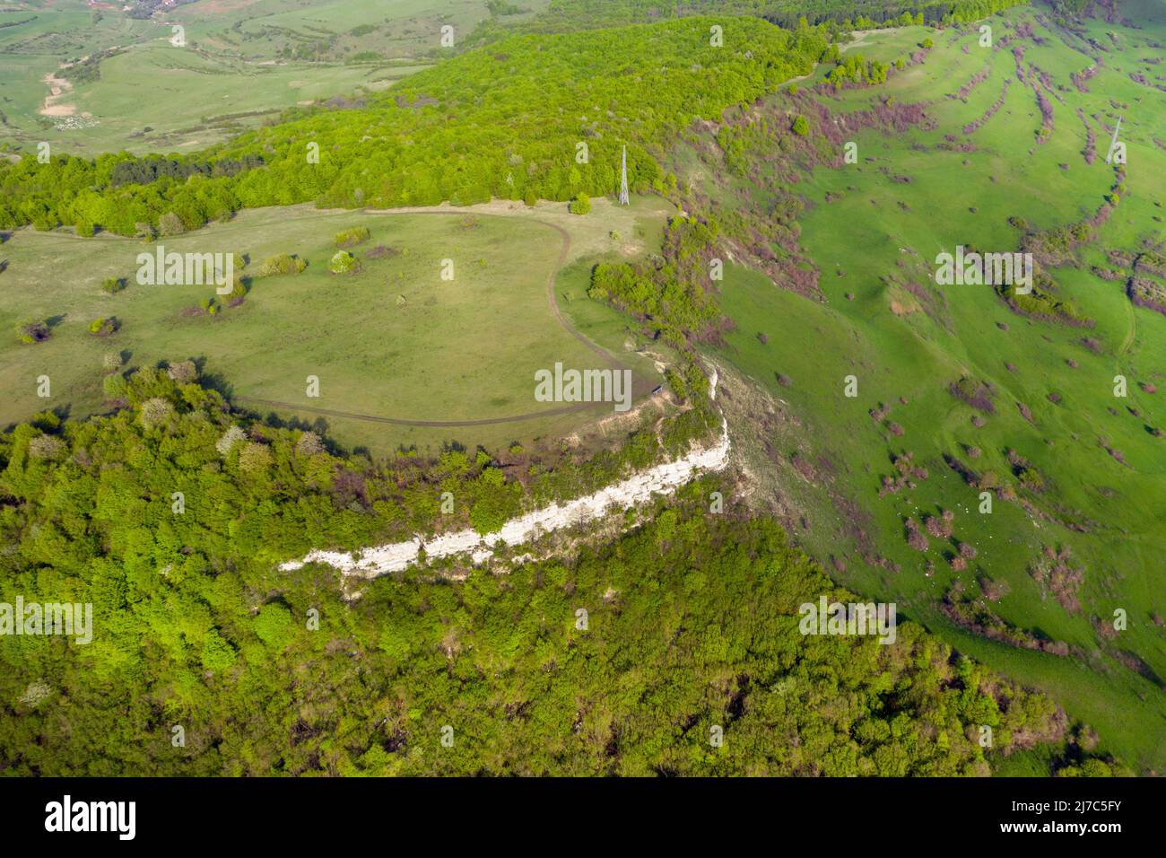 Aerial view of limestone cliffs and Green forest in the spring. Geological formation in Transylvania, Romania Stock Photo