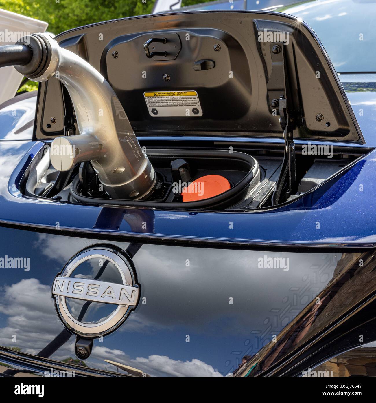 Nissan Leaf connected to a charging station Stock Photo