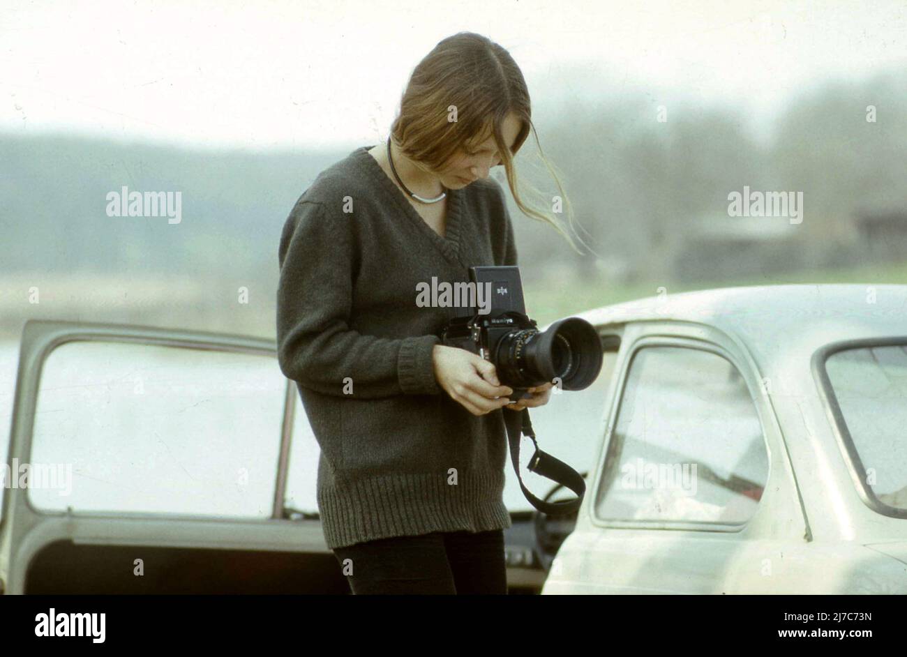 Young woman using a Mamiya camera in the 1970s Stock Photo