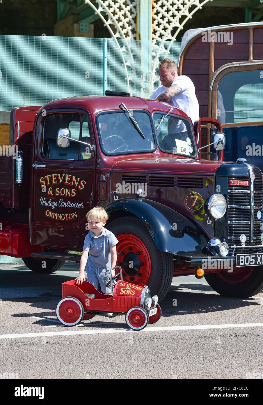 Brighton UK 8th May 2022 - A father and sons polish their Bedford vans at  the 59th Historic Commercial Vehicle Run  on Brighton seafront after arriving from South London . About 200 vehicles which have to be over 20 years old are taking part this year  : Credit Simon Dack / Alamy Live News Stock Photo