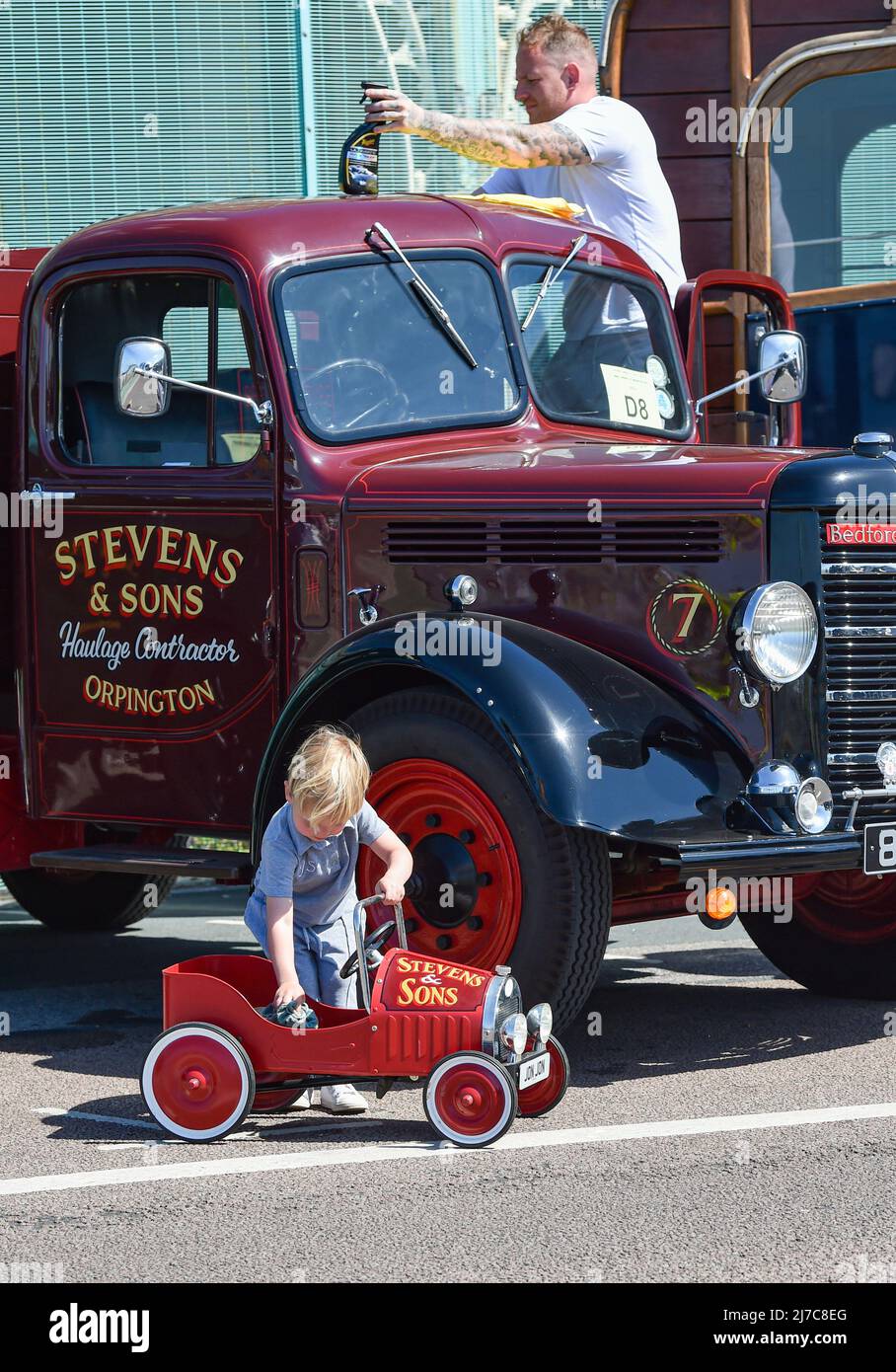 Brighton UK 8th May 2022 - A father and sons polish their Bedford vans at  the 59th Historic Commercial Vehicle Run  on Brighton seafront after arriving from South London . About 200 vehicles which have to be over 20 years old are taking part this year  : Credit Simon Dack / Alamy Live News Stock Photo