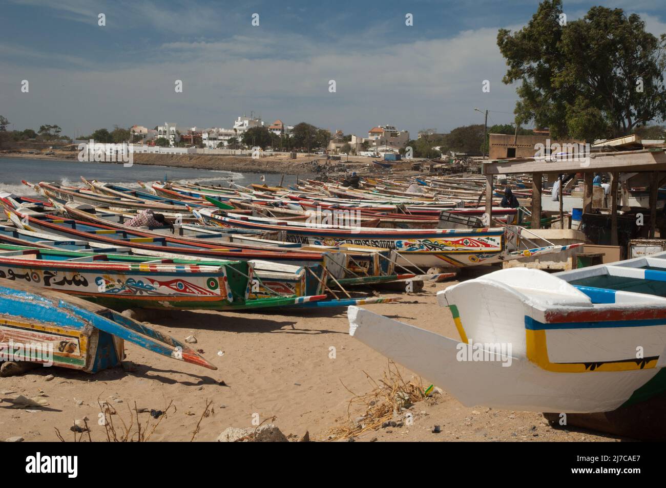 Fishing boats and a man sleeping on one of them. Soumbedioune. Dakar ...