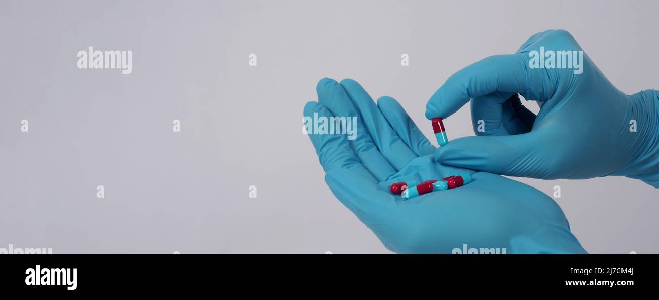 Medication In Hand Taking or holding medication pills in hand. Capsule pill on white ...