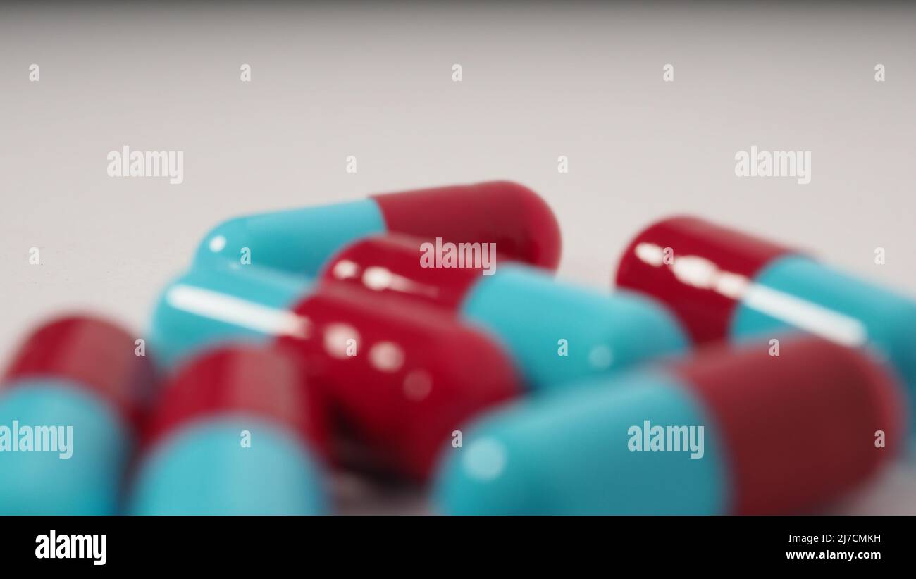 Taking or holding medication pills in hand. Capsule pill on white background isolated. Nitrile