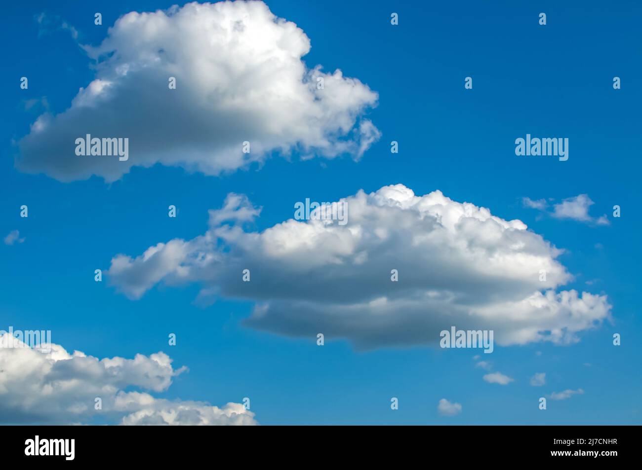 blue sky with fluffy clouds Cumulus, Stratocumulus, clouds lit by side light, background with clouds Stock Photo