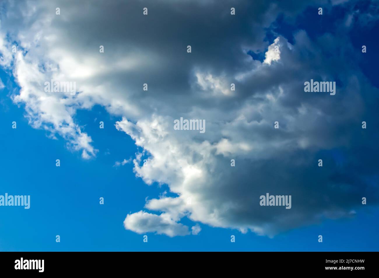 blue sky with fluffy clouds Cumulus, Stratocumulus, clouds lit by side light, background with clouds Stock Photo