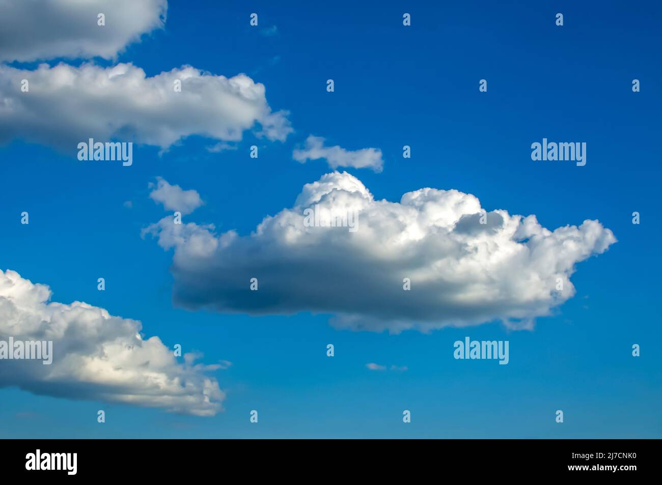 blue sky with fluffy clouds Cumulus, Stratocumulus, clouds lit by side light, background with clouds Stock Photo