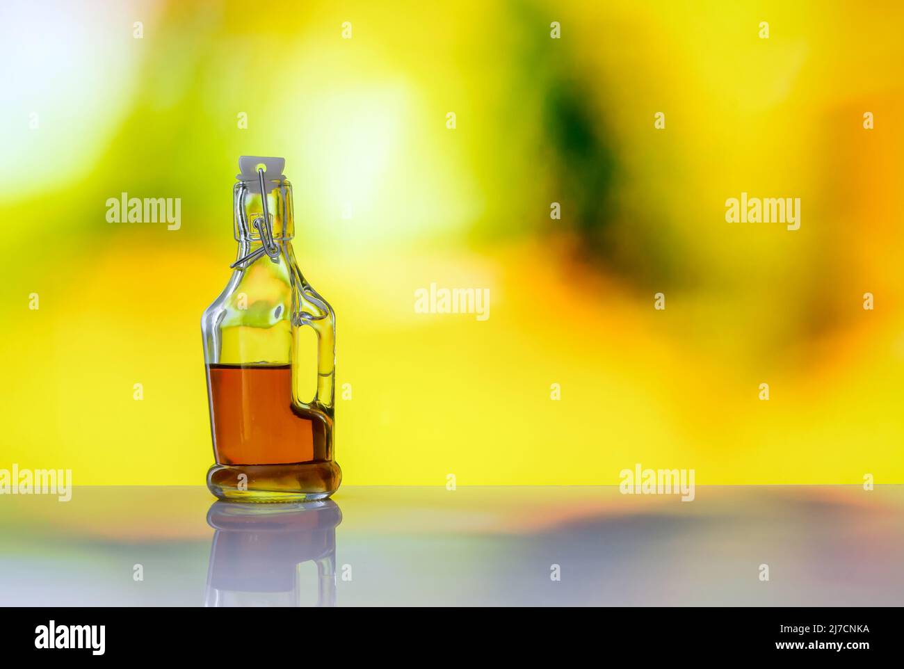 stylish bottle with colored alcohol on a soft blurred background Stock Photo