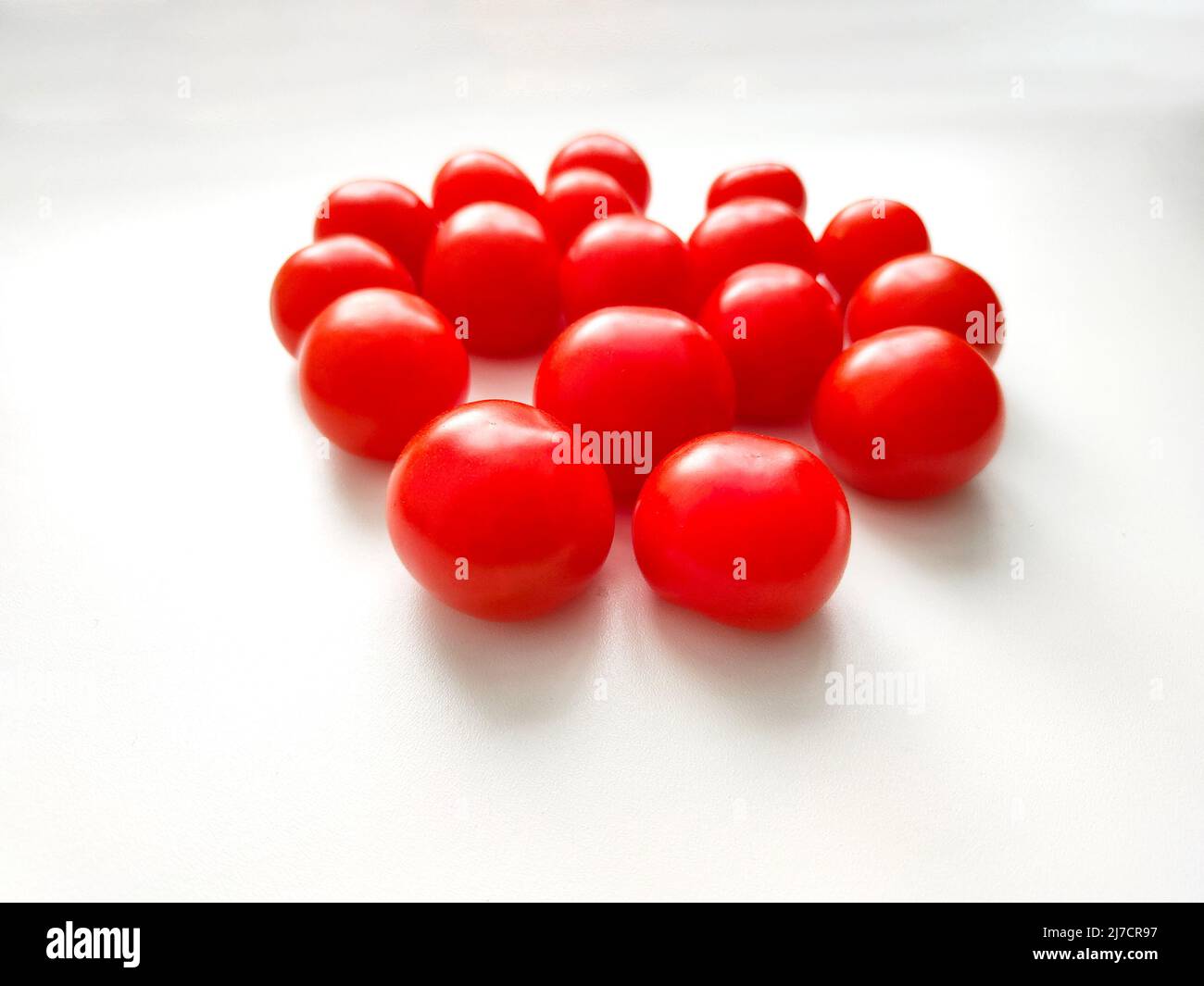 Red cherry tomatoes on white background. Top view. Stock Photo