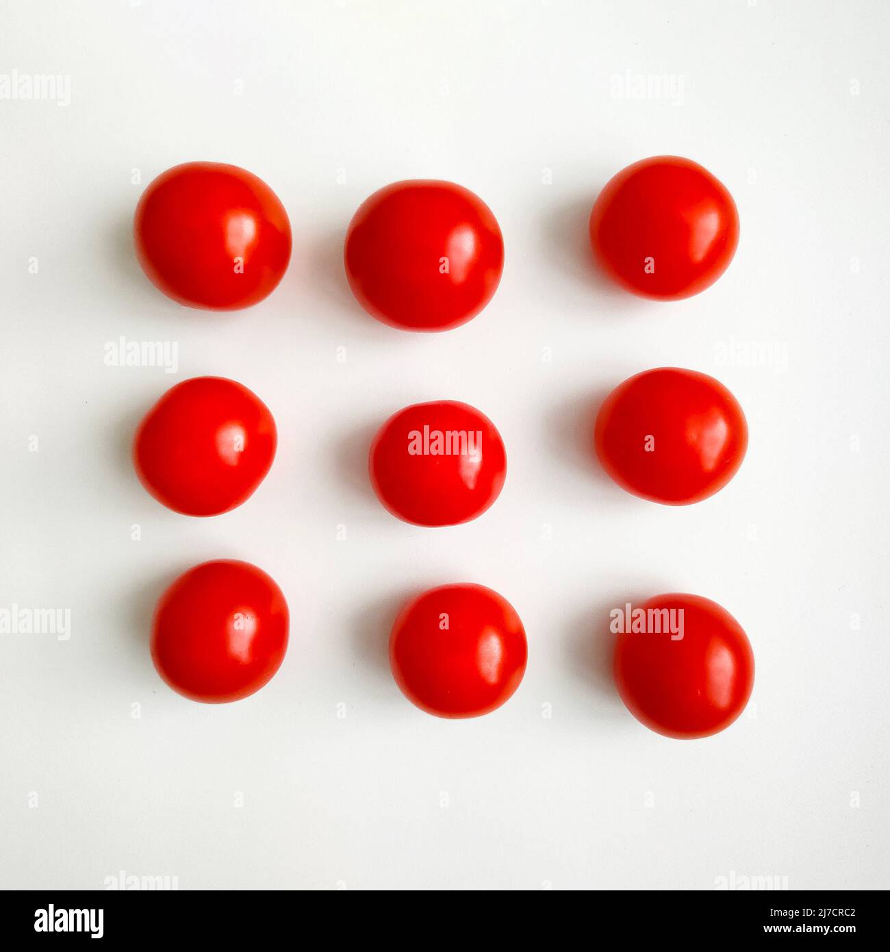 Red cherry tomatoes on white background. Top view. Stock Photo