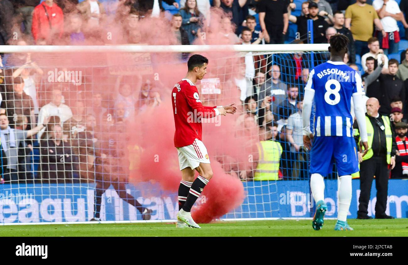 Cristiano Ronaldo of Manchester United leaves the pitch against a backdrop of a red flare during  the Premier League match between Brighton and Hove Albion and Manchester United at the American Express Stadium  , Brighton , UK - 7th May 2022  Editorial use only. No merchandising. For Football images FA and Premier League restrictions apply inc. no internet/mobile usage without FAPL license - for details contact Football Dataco Stock Photo