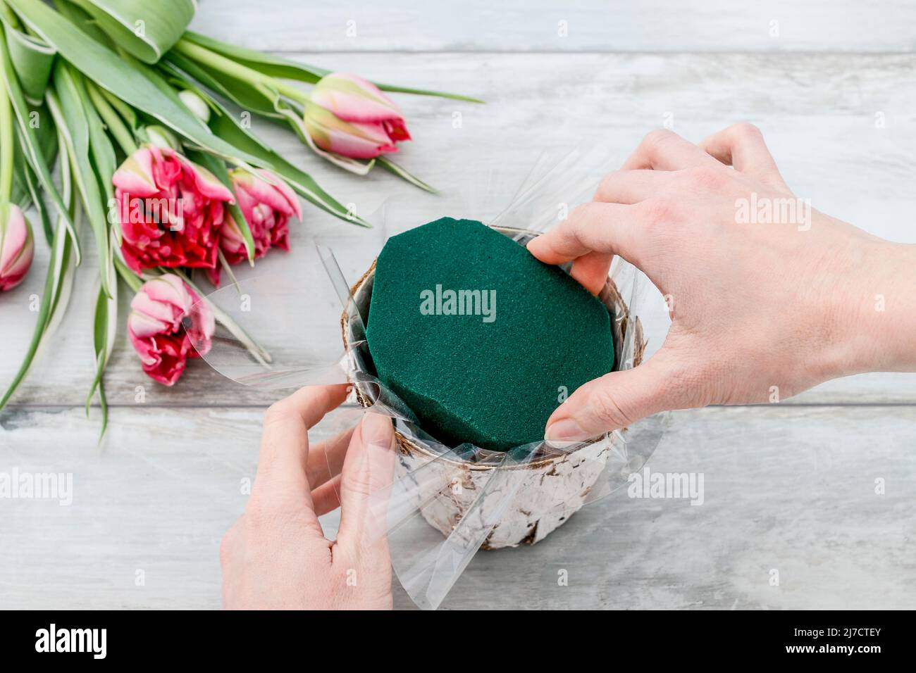 Florist workplace how to make decoration with pink tulips inside