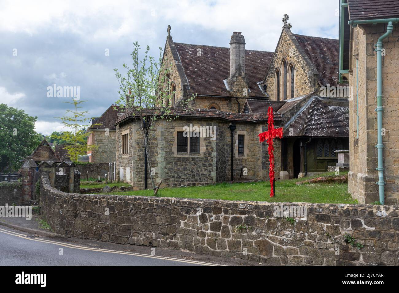 St Bartholomew's Church in Haslemere, Surrey, England, UK, with cross decorated with red ribbons for Easter Stock Photo