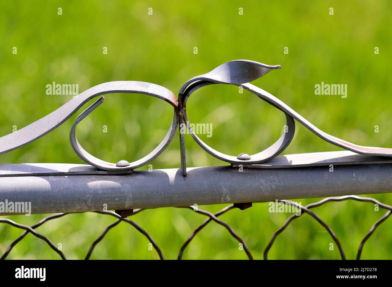 Simple ornament on a metal gate, with curved lines. Stock Photo