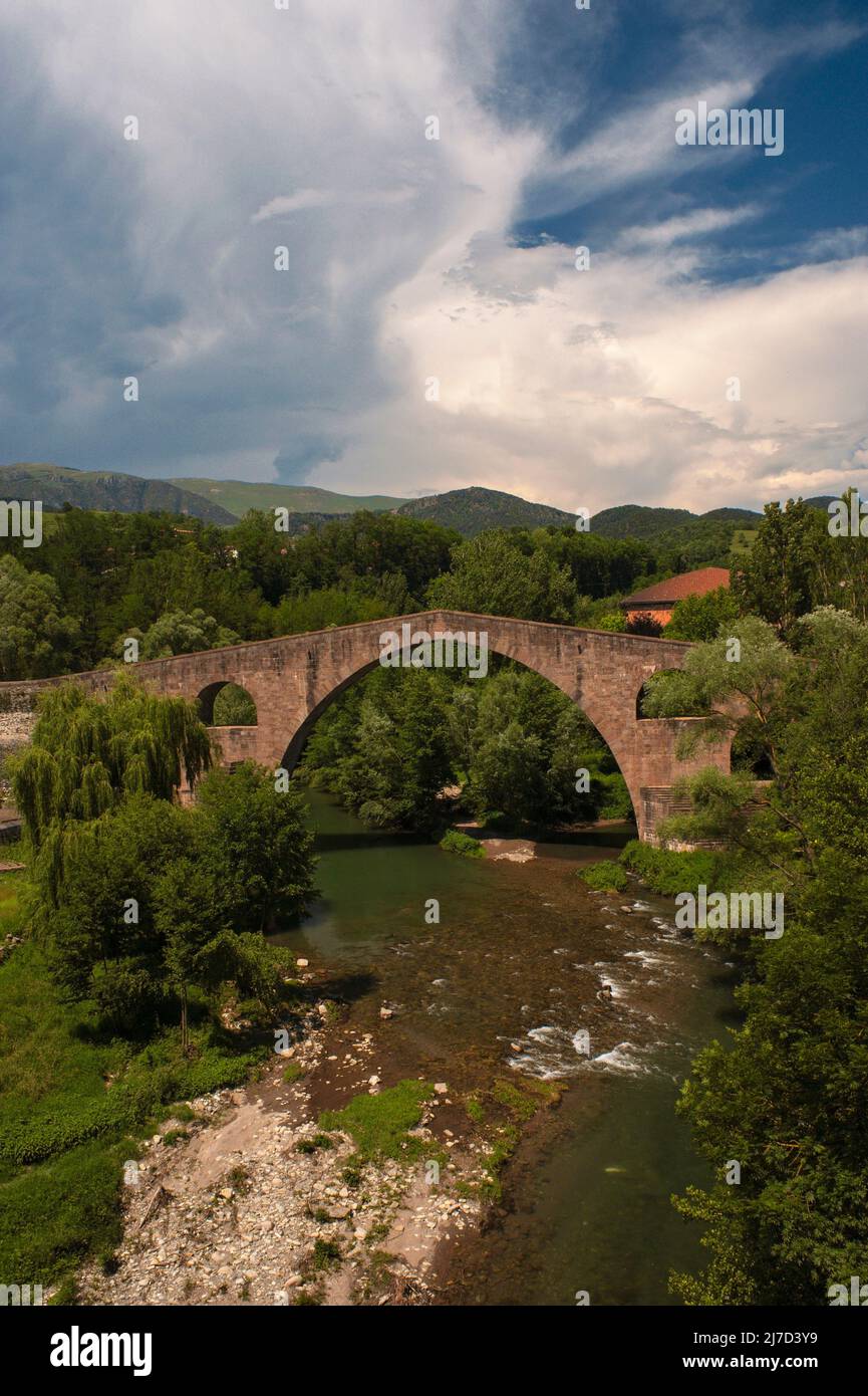 Blown up in the 1930s Spanish Civil War ... but the ancient Pont Vell or Old Bridge over the River Ter at Sant Joan de les Abadesses in Catalonia, Spain, is now restored to its former Gothic glory with its slender pointed arch making it the lightest bridge of its type on the Iberian Peninsula. Stock Photo