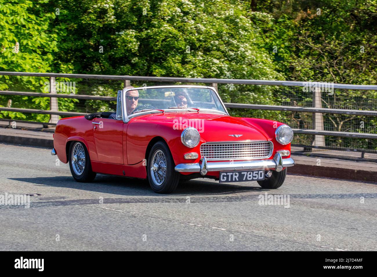 1966 60s sixties red Austin Healy Sprite.1098cc petrol cabriolet driving on the M61 Motorway, Manchester, UK Stock Photo