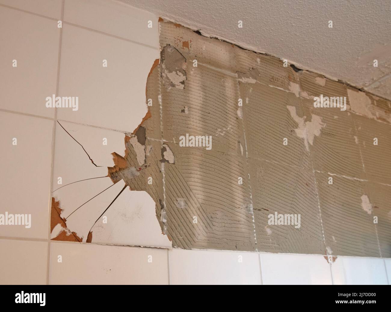 Breaking ceramic tiles, work in progress, maintenance Stock Photo Alamy