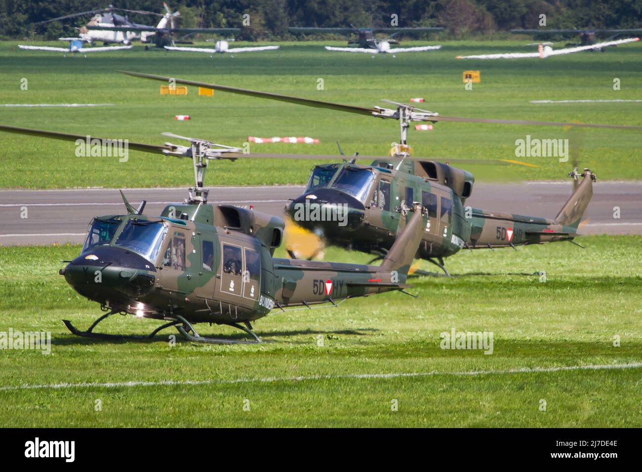 Two Austrian Air Force Bundesheer transport helicopters Bell 212 landing to bring special forces into the battlefield Stock Photo