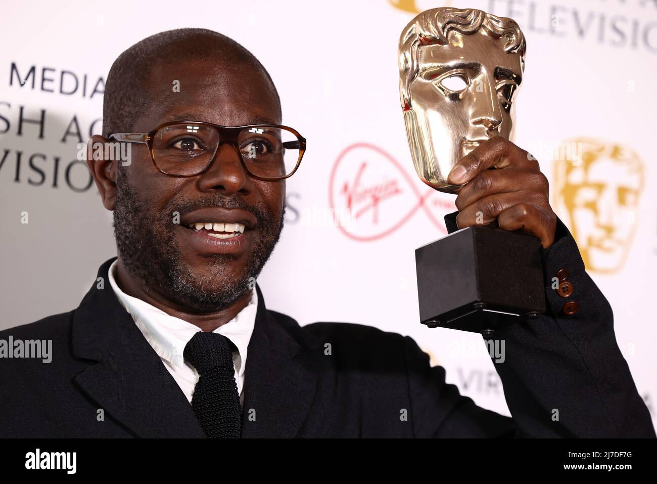 Director Steve McQueen poses with the 'Best Factual Series' award for 'Uprising' at the British Academy Television Awards in London, Britain, May 8, 2022. REUTERS/Henry Nicholls Stock Photo