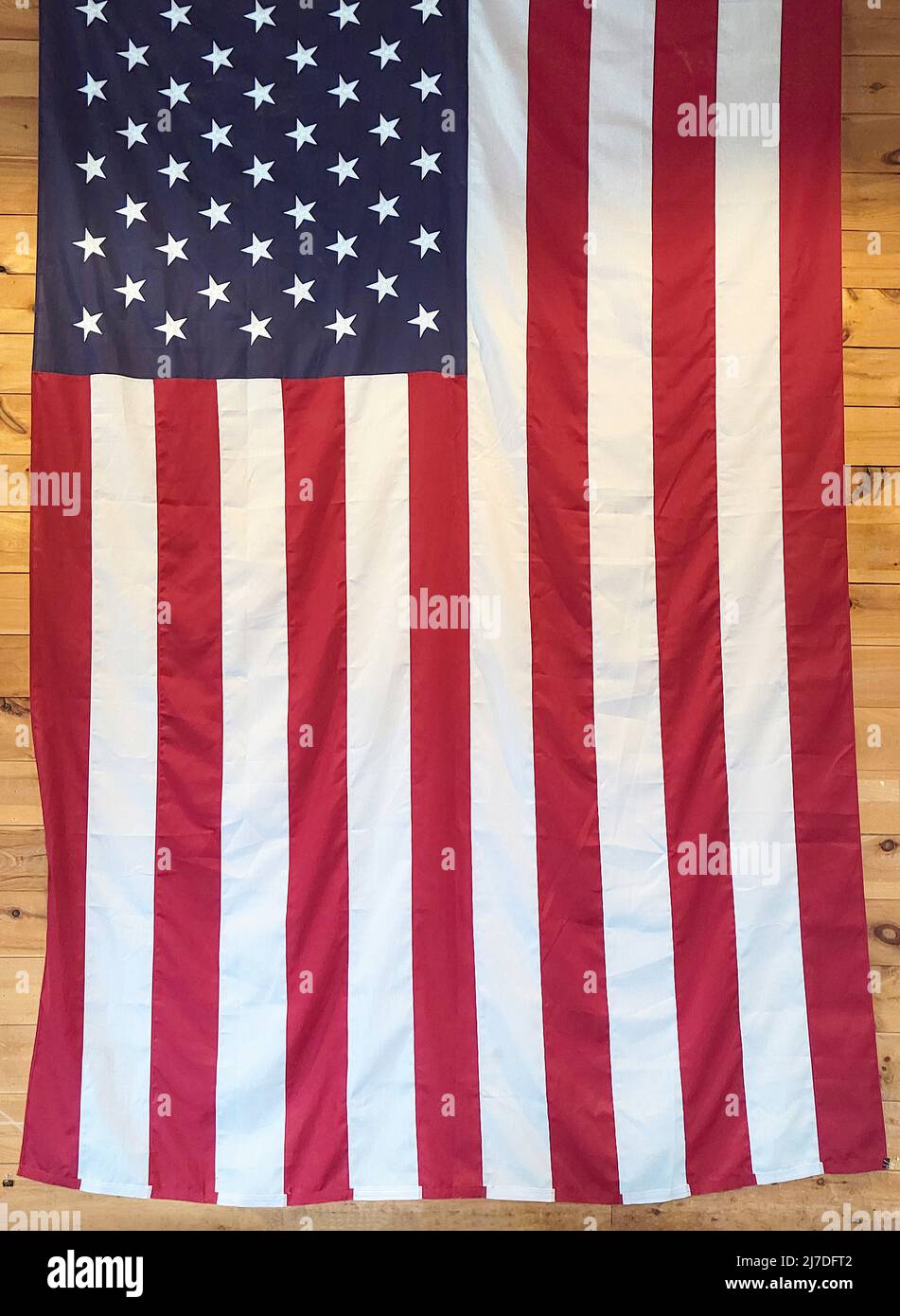 American flag hanging on a wooden wall Stock Photo