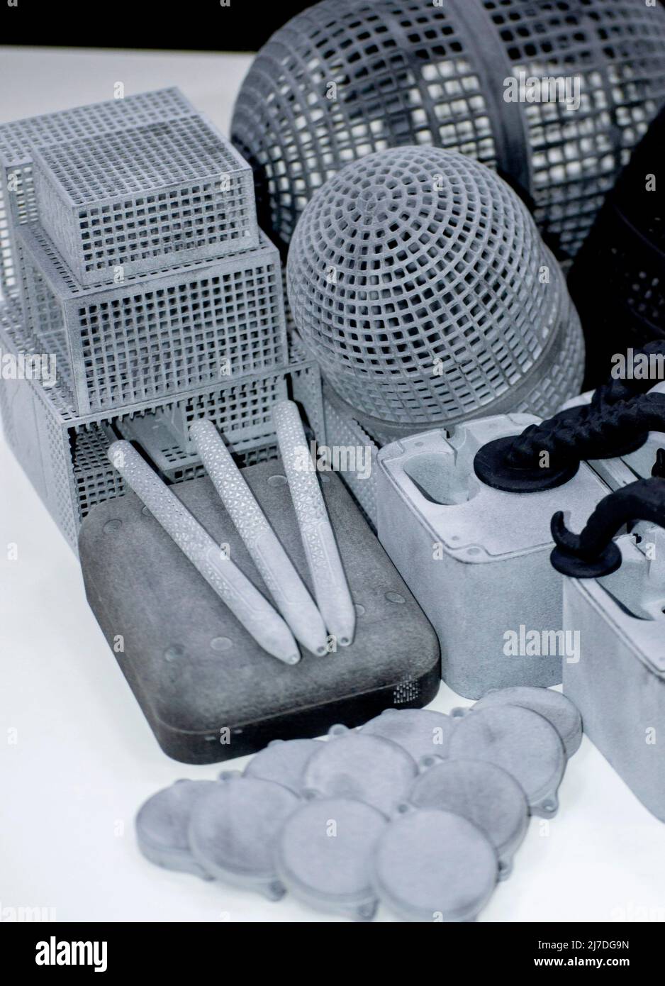 Many different models printed on 3D printer. Gray and black objects printed Stock Photo