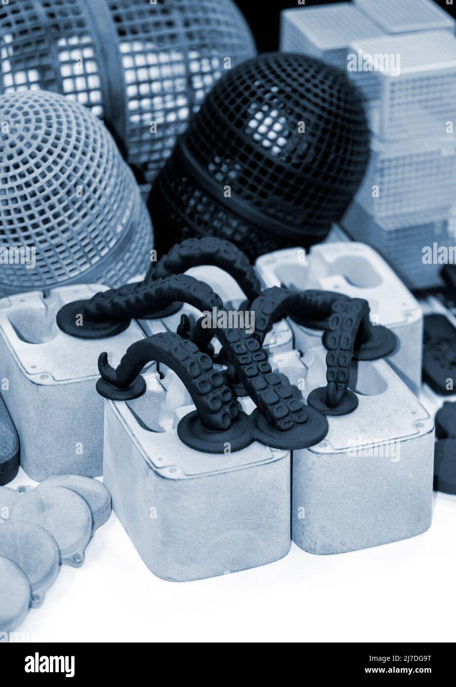 Many different models printed on 3D printer. Gray and black objects printed Stock Photo
