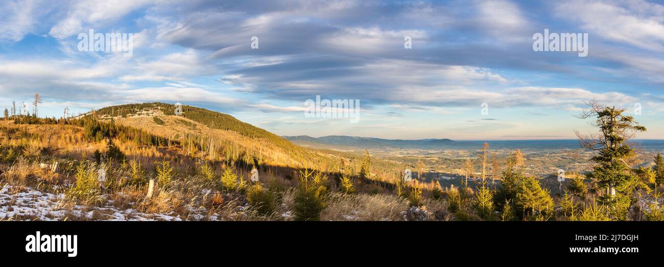 Beautiful evening weather mood in the mountains with setting sun and interesting cloud formation Stock Photo
