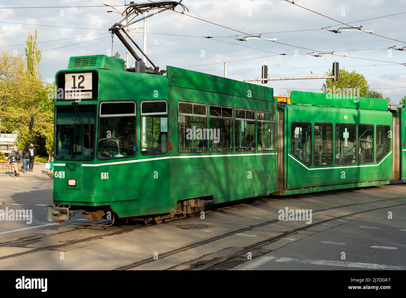 Single Be 4/6 S Schindler/Siemens or Schindler Waggon AG Be 4/6 green tram or Green Cucumber on empty street with no cars in downtown Sofia Bulgaria Stock Photo