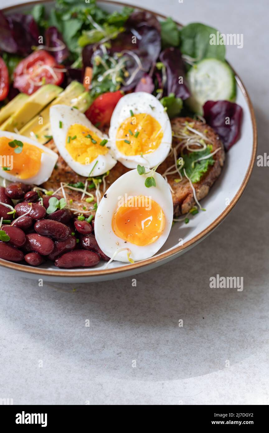 Medium boiled eggs with sasld, healthy breakfast Stock Photo