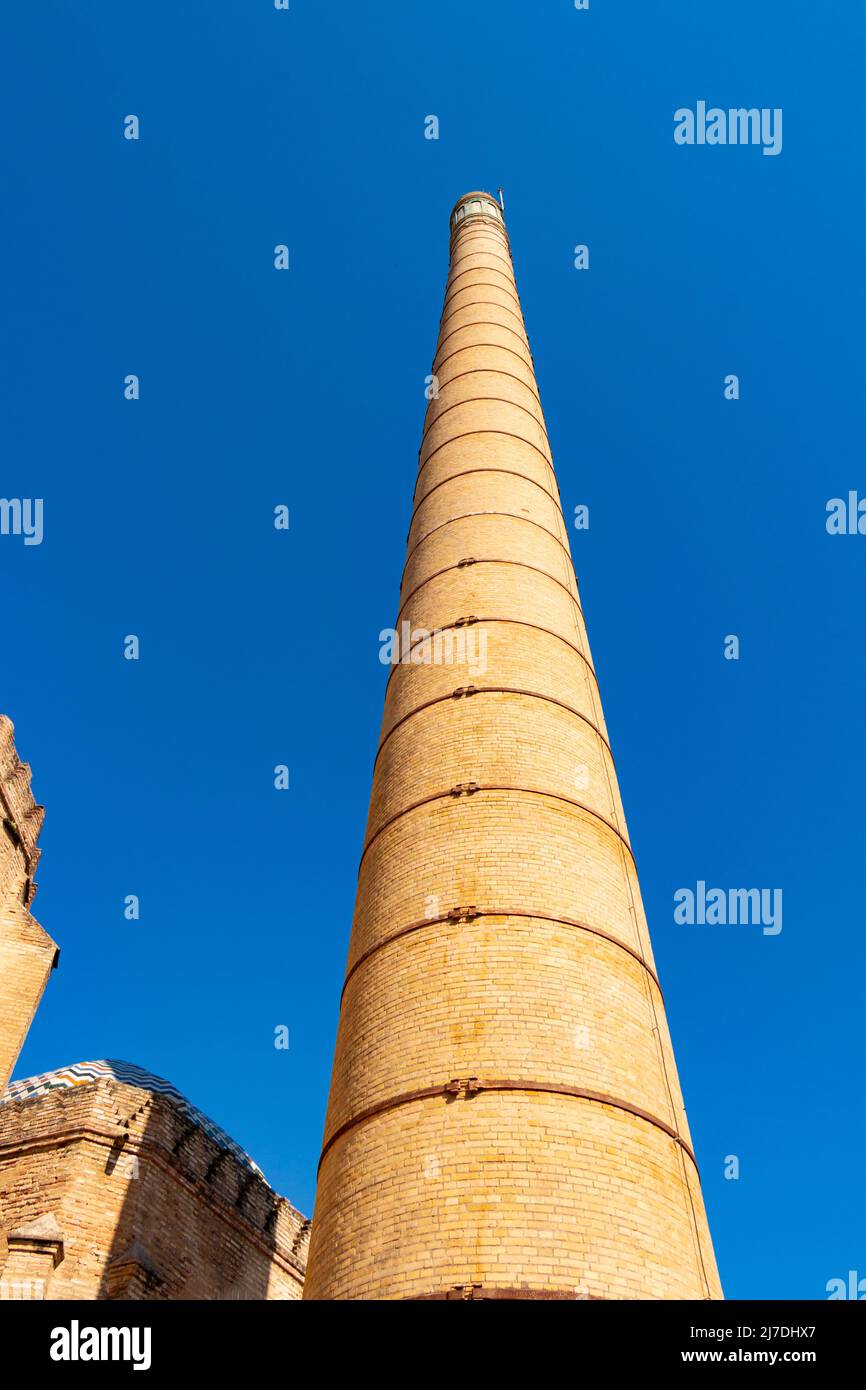 tall brick chimney against blue sky  Andaluz  contemporary art museum in ceramics factory and monastery Isla de La Cartuja seville Sevilla Spain Stock Photo
