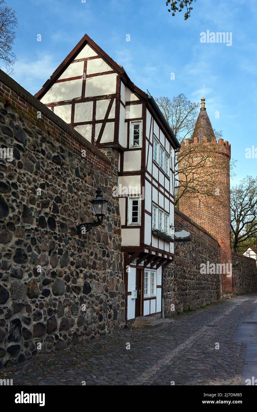 Stone, medieval walls with a historic tower of a twostory house in the