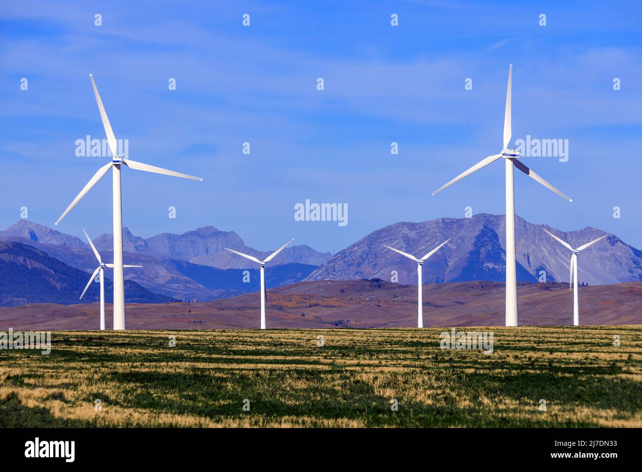A wind turbine is a device that converts the kinetic energy of wind into electrical energy in installations known as wind farms. Stock Photo