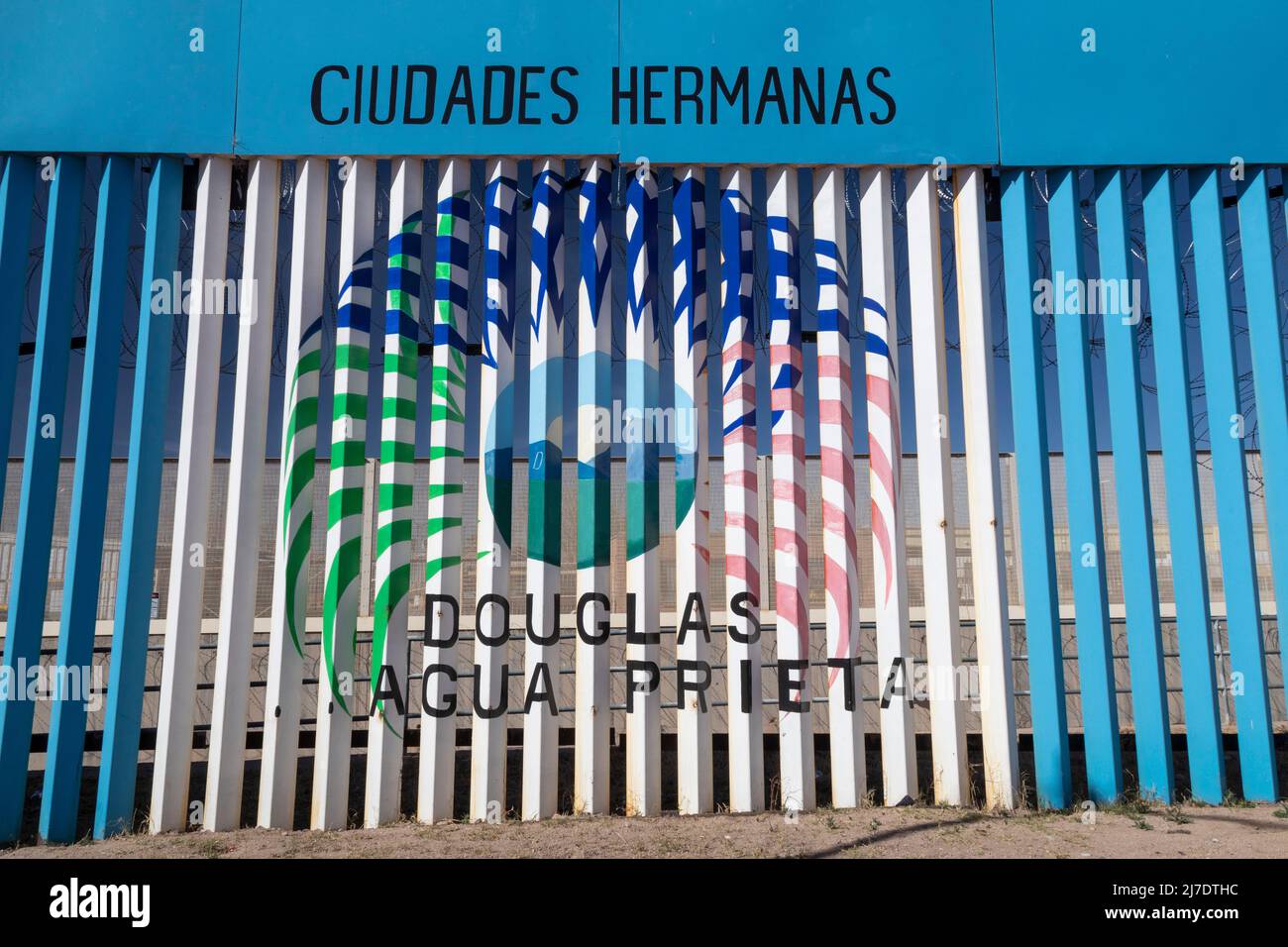 Agua Prieta, Mexico - Artwork proclaims Agua Prieta and Douglas, Arizona 'sister cities.' The art is painted on the U.S.-Mexico border fence that divi Stock Photo