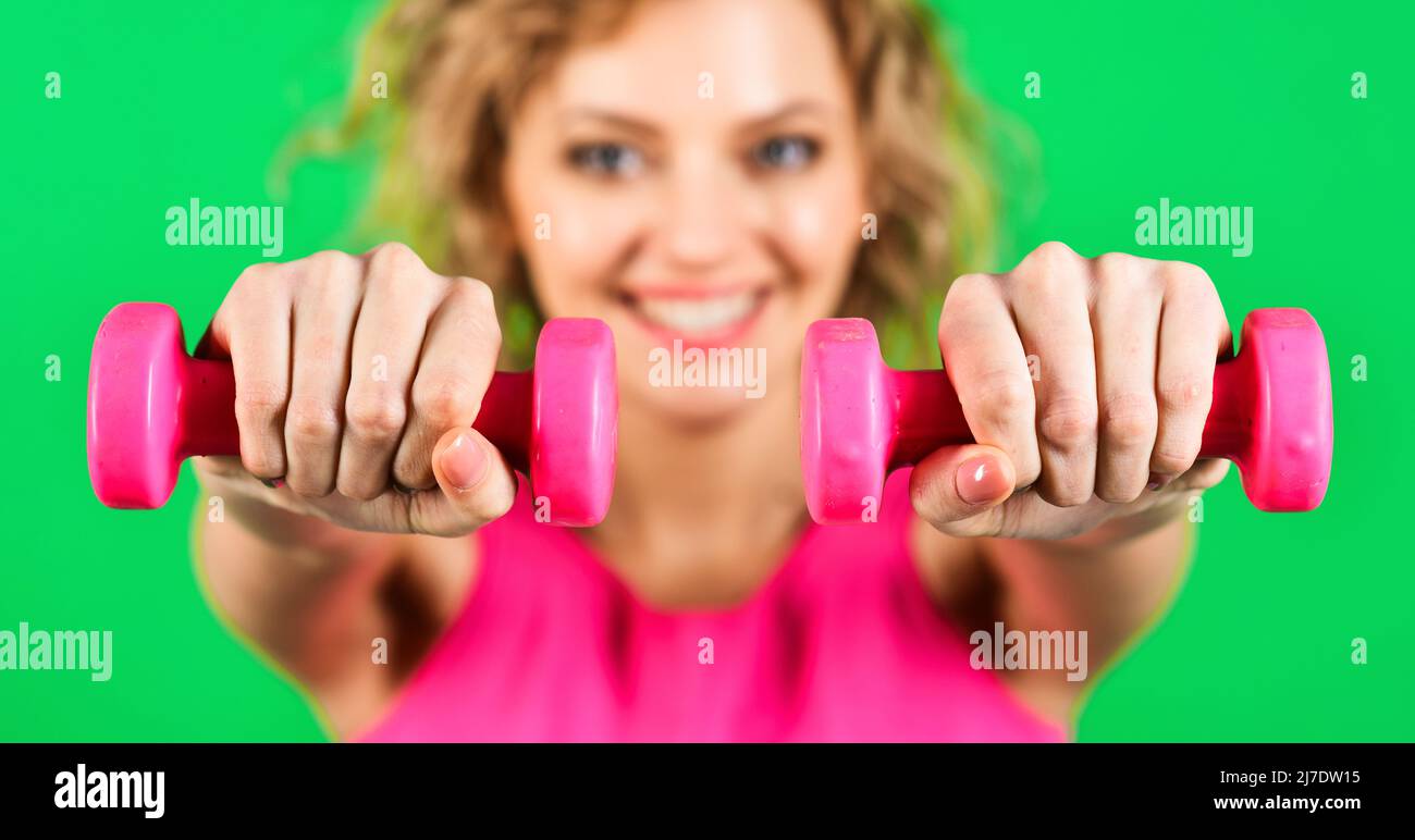 Sport equipment. Sporty woman with dumbbells. Fitness training. Sports and healthy lifestyle. Stock Photo