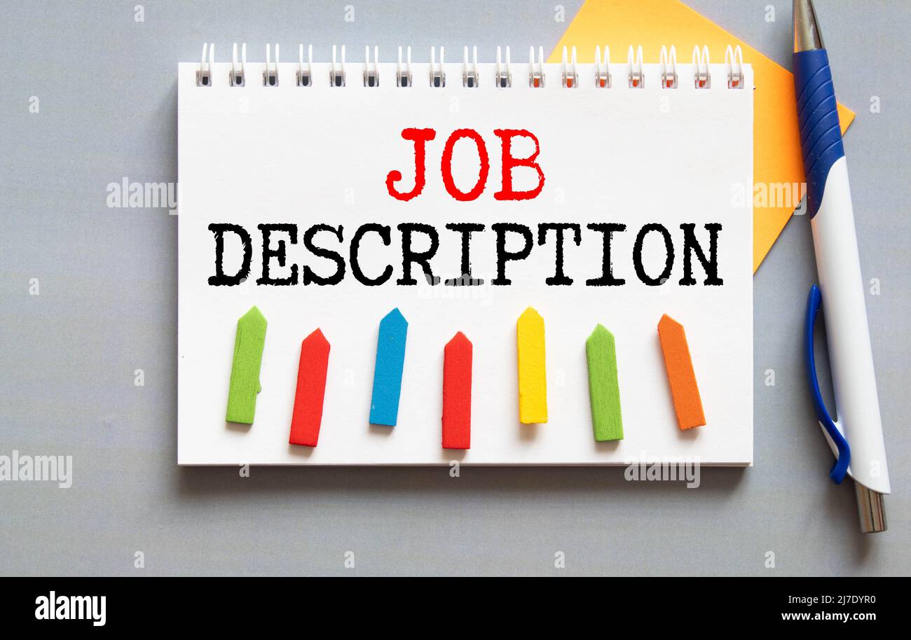 Handwriting text writing Job Description on paper above pc keyboard for