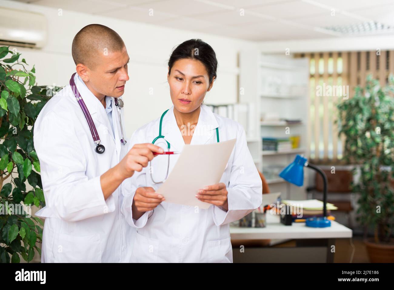 two-doctors-discussing-about-medical-report-stock-photo-alamy