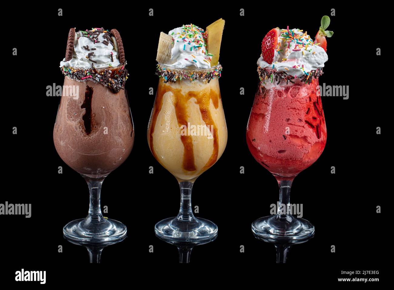 https://c8.alamy.com/comp/2J7E3EG/three-glasses-of-milkshake-with-assorted-flavors-chocolate-ananas-and-strawberry-milkshake-2J7E3EG.jpg