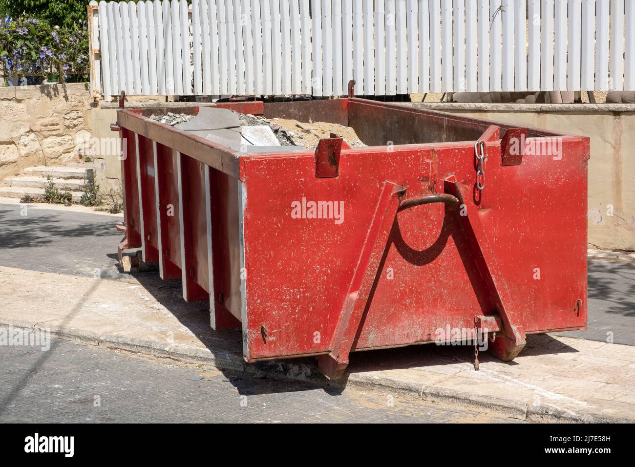 Construction waste in a half empty Red dumpster. Waste metal tank ...