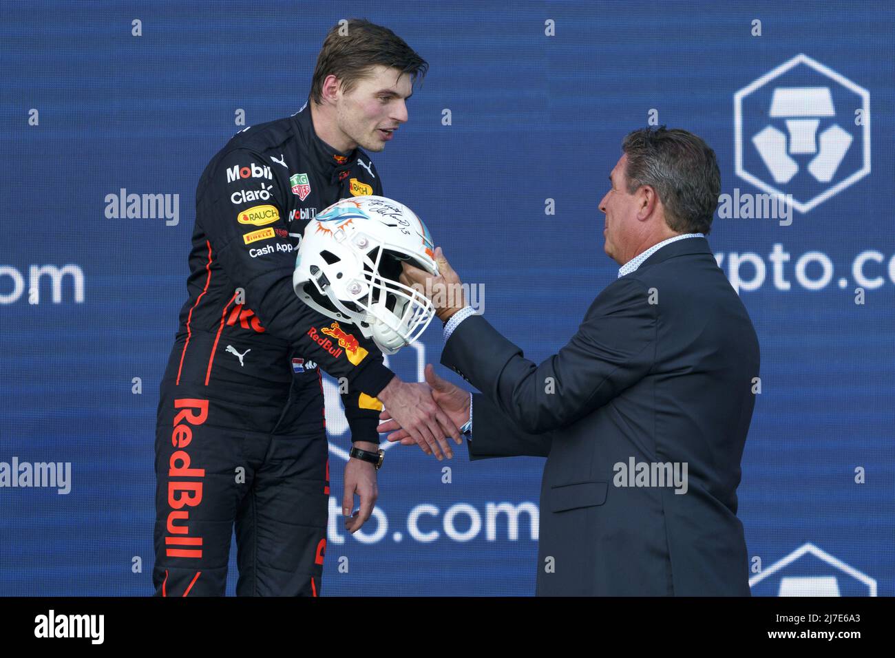 Miami Gardens, Florida, May 8, 2022. Dutch Formula One driver Max  Verstappen of Red Bull Racing holds a Miami Dolphins helmet signed by Dan  Marino and the first place trophy during the
